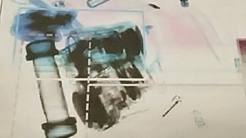 This is the very security photo from the Edmonton Airport.  Observe cylindrical object on left.   